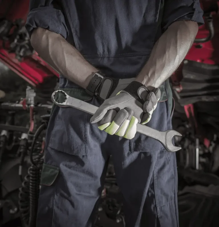 Mechanic holding a wrench in front of a car during roadside assistance – Lakeland Car Towing & Roadside Assistance offering professional help in Polk County