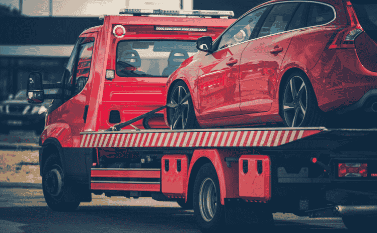Flatbed tow truck transporting a broken-down car in Lakeland, FL – 24/7 towing by Lakeland Car Towing & Roadside Assistance